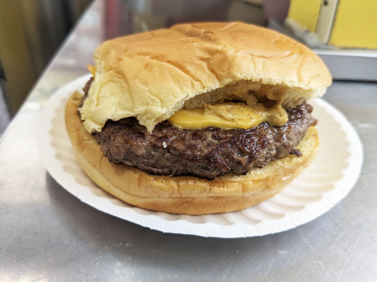 A cheeseburger with a sad looking bun.