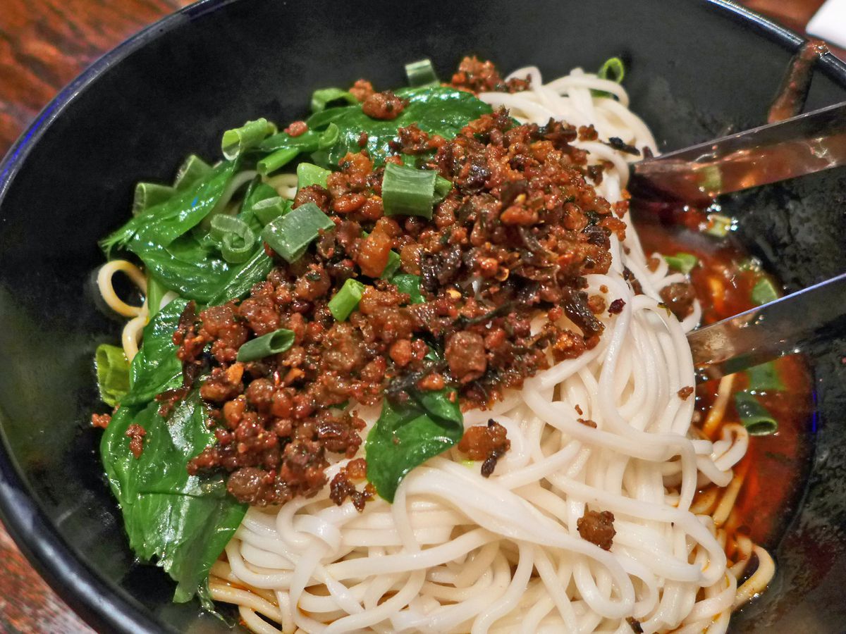 Spaghetti like noodles with ground meat sauce and chopped scallions