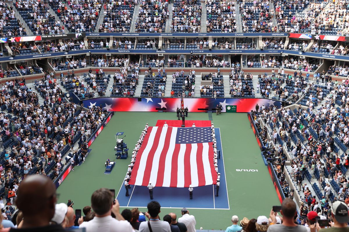 A general view is seen as members of the Military unfurl the American flag before the Men’s Singles final match between Daniil Medvedev of Russia and Novak Djokovic of Serbia on Day Fourteen of the 2021 US Open at the USTA Billie Jean King National Tennis Center on September 12, 2021 in the Flushing neighborhood of the Queens borough of New York City.