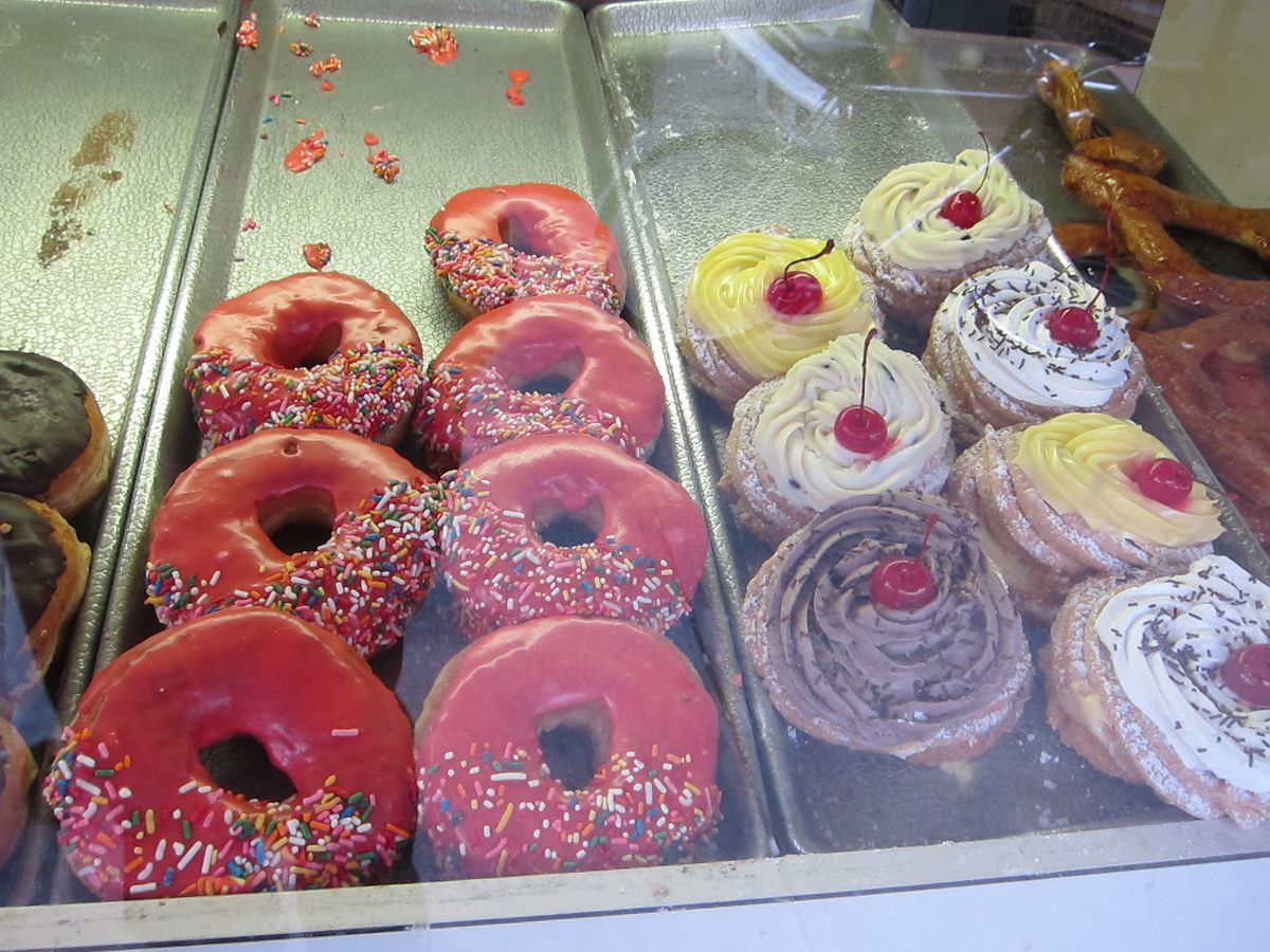 Colorful donuts lined up in columns, some red, some pink.