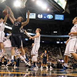 Brigham Young Cougars guard Matt Carlino (2) and Utah State Aggies center Jordan Stone (25) and Utah State Aggies forward Kyle Davis (23) fight for a rebound during a game at EnergySolutions Arena on Saturday, November 30, 2013.