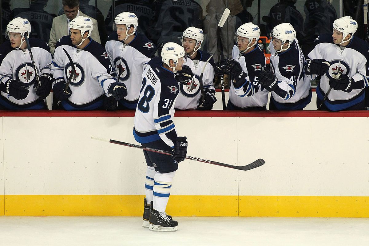 WINNIPEG, CANADA - SEPTEMBER 20: Paul Postma #38 of the Winnipeg Jets is congratulated for his goal against the Columbus Blue Jackets at the MTS Centre on September 20, 2011 in Winnipeg, Manitoba, Canada. (Photo by Marianne Helm/Getty Images)