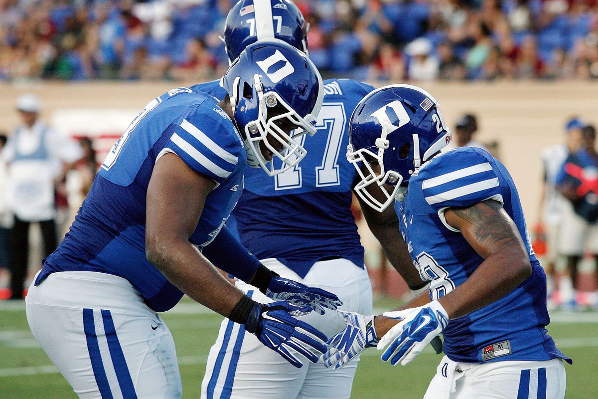 Aug 30, 2014; Durham, NC, USA; Duke Blue Devils offensive tackle Takoby Cofield (73) and running back Shaquille Powell (28) celebrate after Powell scored against the Elon Phoenix at Wallace Wade Stadium. 