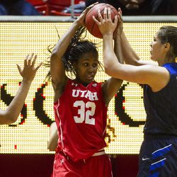 Brigham Young forward Kalani Purcell (32) strips the ball from Utah forward Tanaeya Boclair (32) during an NCAA women's college basketball game in Salt Lake City on Saturday, Dec. 10, 2016. Utah defeated rival Brigham Young 77-60.
