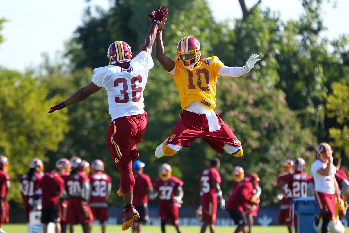 Villanova alum Darrel Young and QB RGIII high-five at Redskins training camp in Richmond, Virginia.