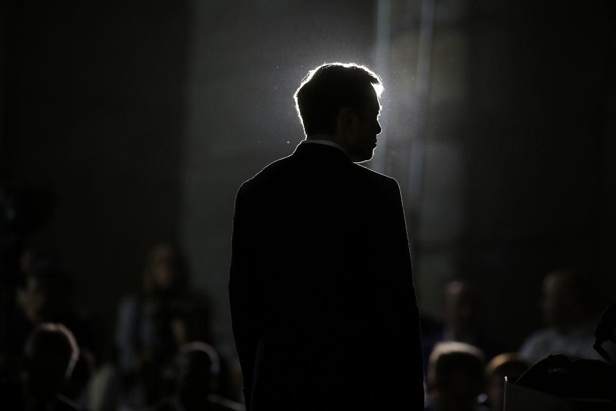 Elon Musk’s profile in silhouette.