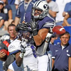 Brigham Young Cougars wide receiver Brett Thompson (19) grabs Weber State Wildcats cornerback Robbie Diamond (6) head instead of the ball as Brigham Young University defeats Weber State University in football 45-6 Saturday, Sept. 8, 2012, in Provo, Utah.