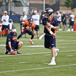 Denver Broncos QB Case Keenum throws a pass during the first day of training camp.
