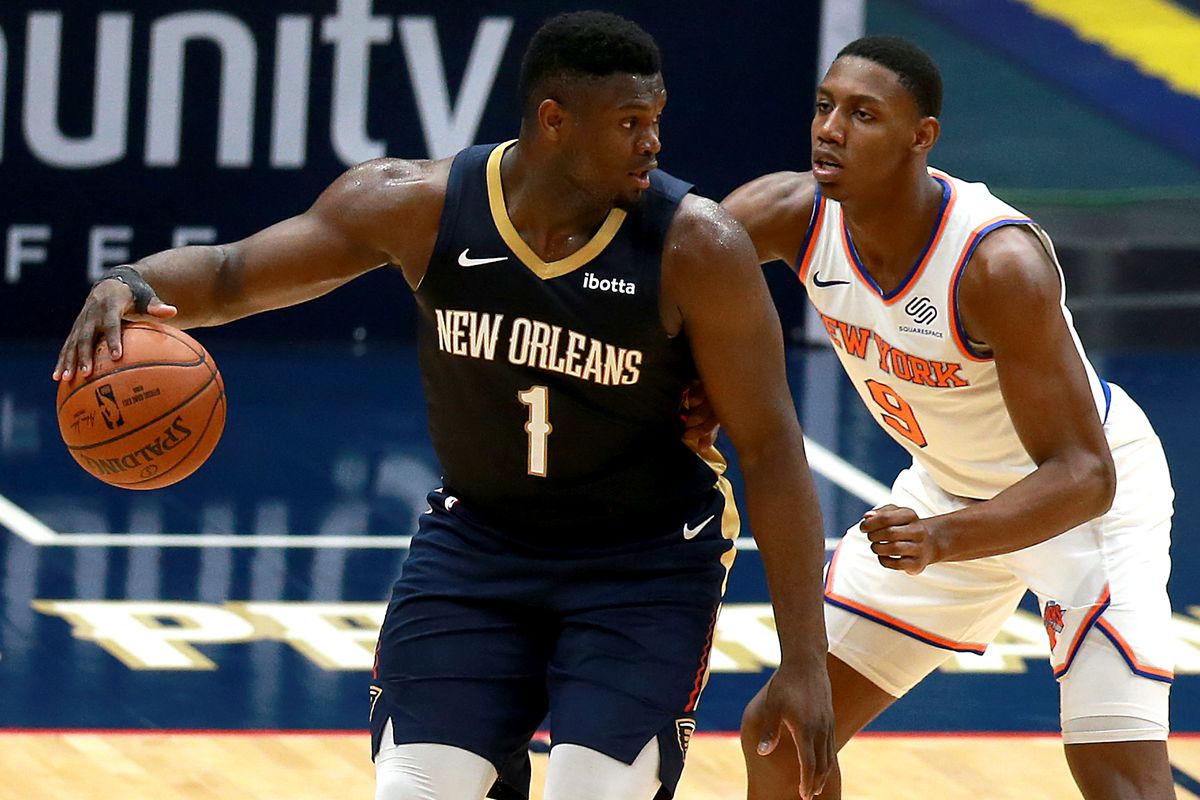 Zion Williamson #1 of the New Orleans Pelicans is defended by RJ Barrett #9 of the New York Knicks during the second quarter of an NBA game at Smoothie King Center on April 14, 2021 in New Orleans, Louisiana.&nbsp;