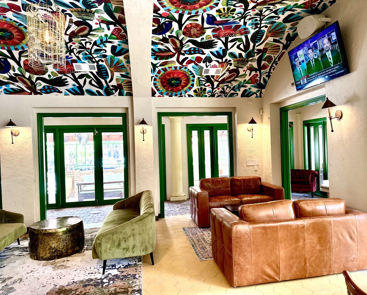 Verde Garden’s indoor space, with leather and suede coaches and ceiling decorated in puebla print.