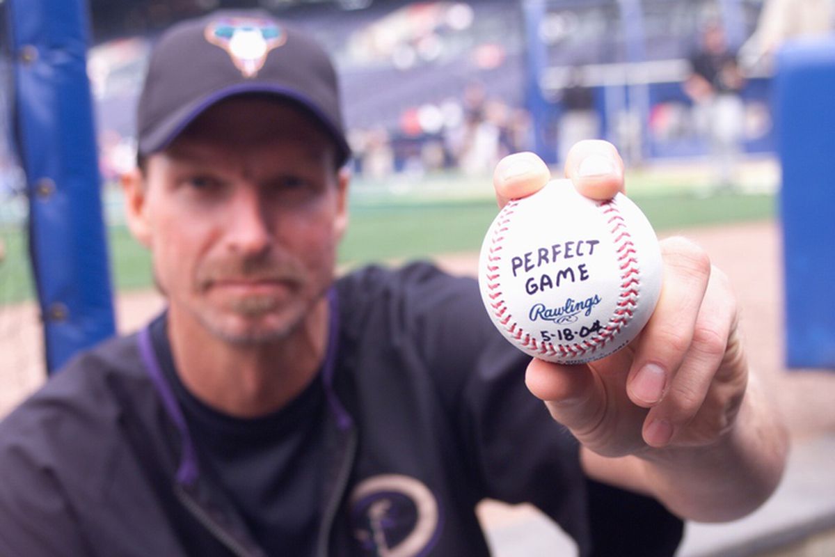 Johnson poses with a ball at Turner Field, the day after his perfect game.
