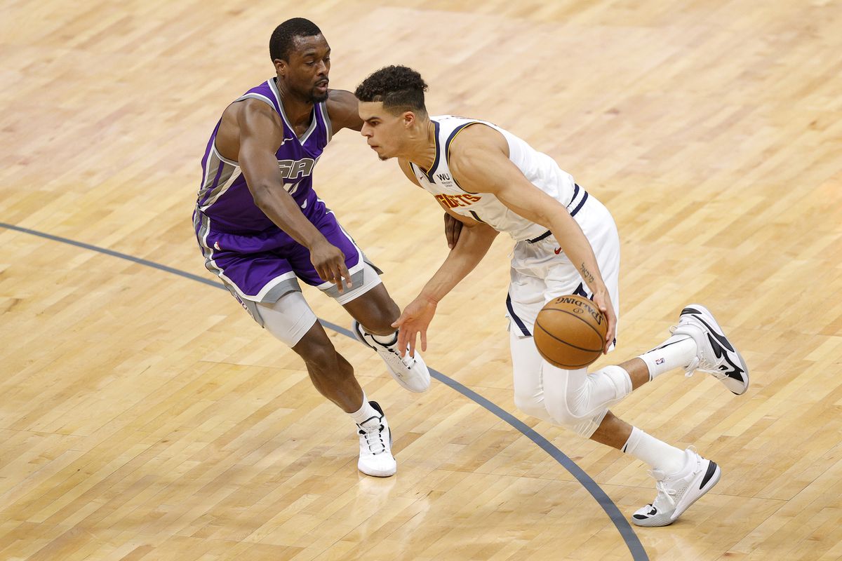 Michael Porter Jr. of the Denver Nuggets is guarded by Harrison Barnes of the Sacramento Kings at Golden 1 Center on December 29, 2020 in Sacramento, California.&nbsp;