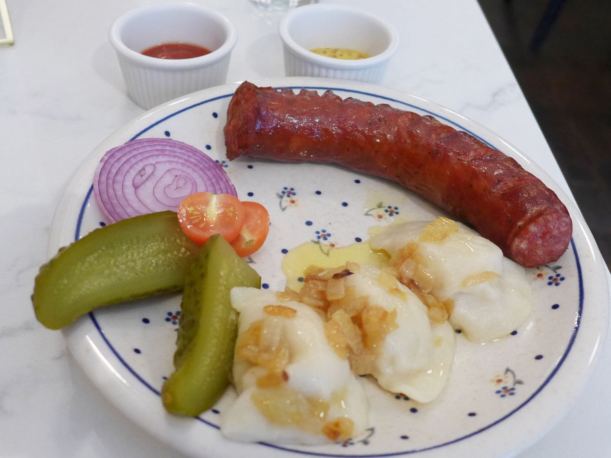 A long sausage with three dumplings.