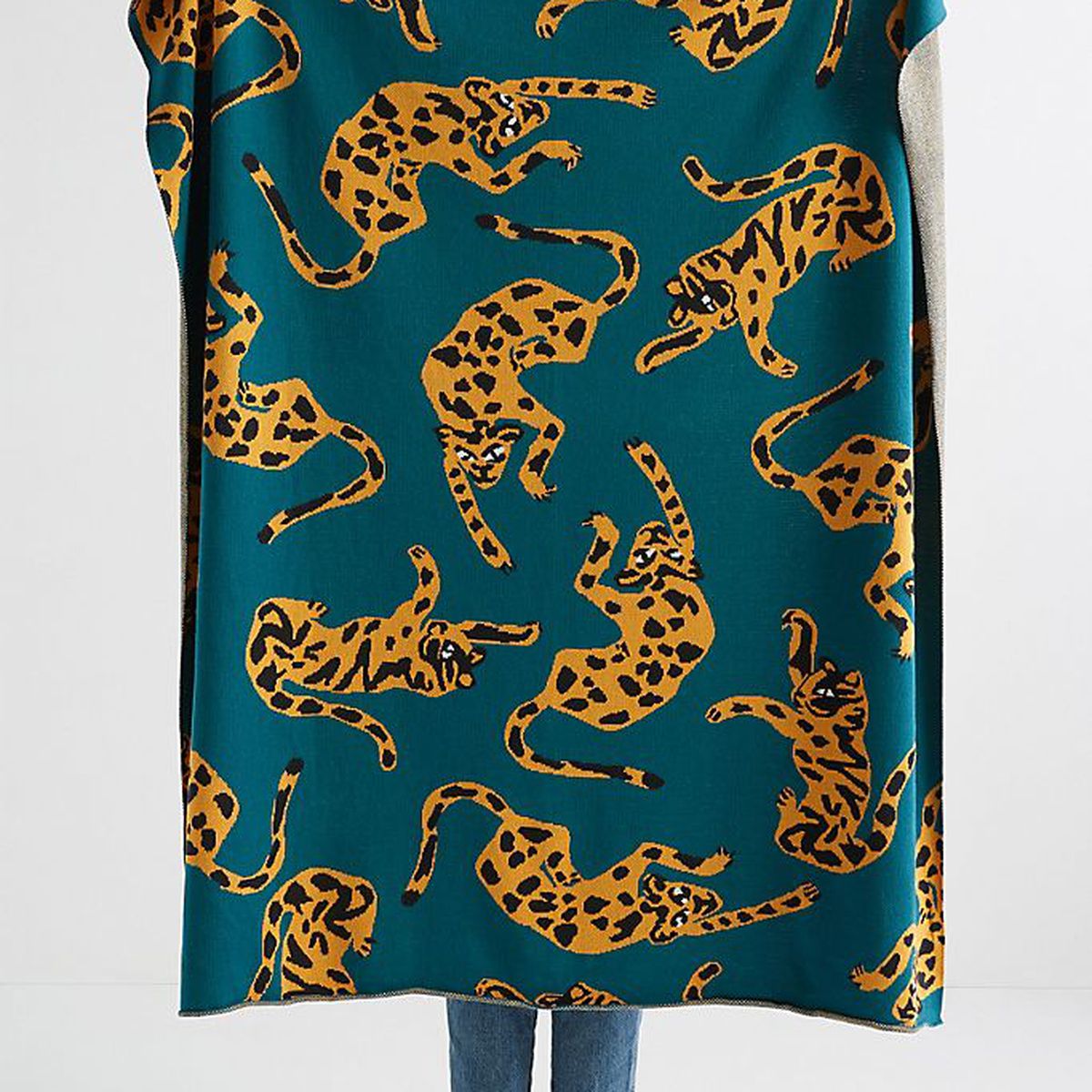 A teal blanket with a leopard print