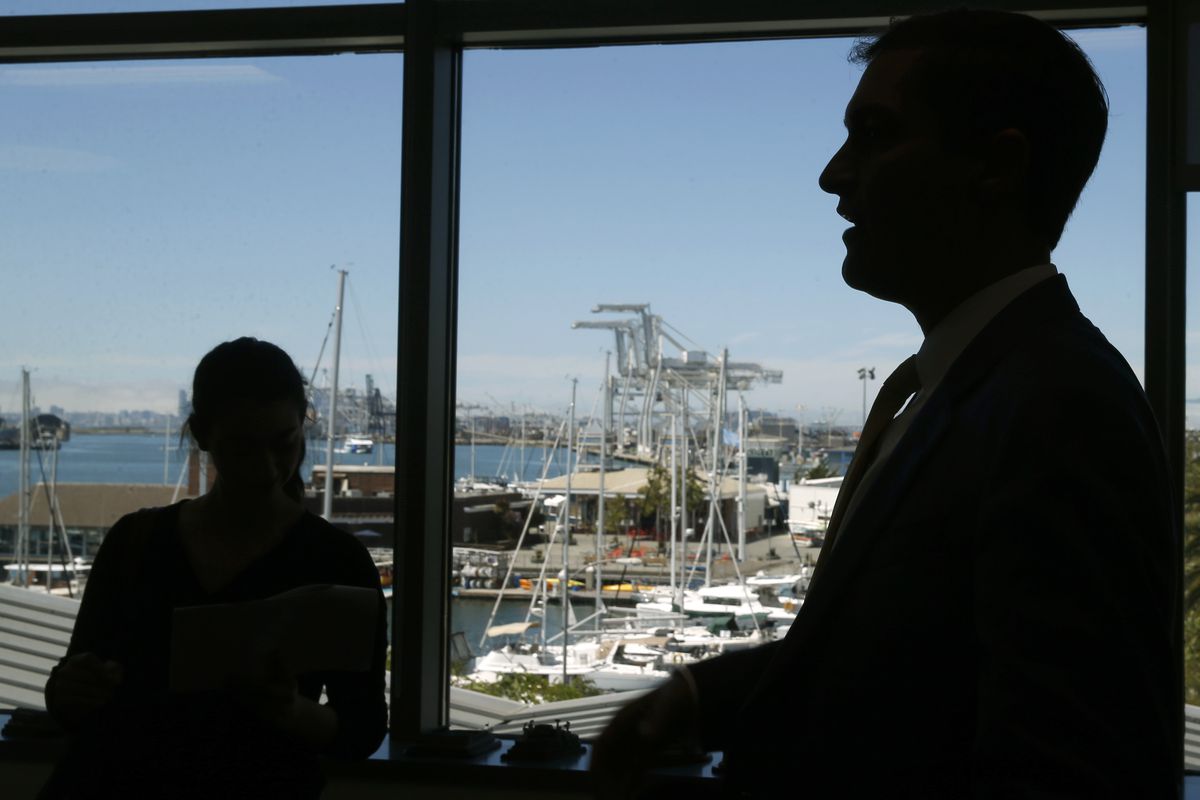 Oakland A’s President Dave Kaval welcomes visitors to his office at Jack London Square overlooking Howard Terminal (background) before leading a private tour of the site in Oakland, Calif. on Tuesday, Sept. 3, 2019 where the baseball team is hoping to bui
