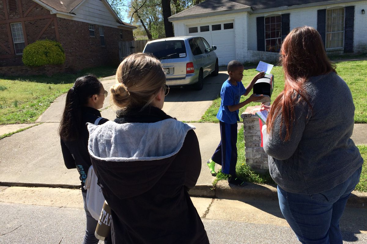 Staff members of Green Dot Public Schools canvass a neighborhood near Kirby Middle School in the summer of 2016 before reopening the Memphis school as a charter.