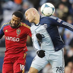 Real's Robbie Findley and Sporting's Aurelien Collin battle for the ball as Real Salt Lake and Sporting KC play Saturday, Dec. 7, 2013 in MLS Cup action.