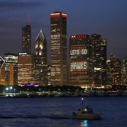 The Chicago skyline displays the Chicago Blackhawks' red and words of encouragement, Friday, June 21, 2013, in Chicago. The Blackhawks will face the Boston Bruins in Game 5 of the Stanley Cup Final series Saturday. (AP Photo/Charles Rex Arbogast)