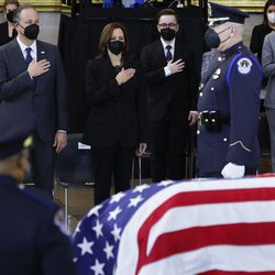 Vice President Kamala Harris places her hand over her heart as the flag-draped casket of former Senate Majority Leader Harry Reid, D-Nev., is moved into position in the Rotunda of the U.S. Capitol where he will lie in state, Wednesday, Jan. 12, 2022, in Washington.