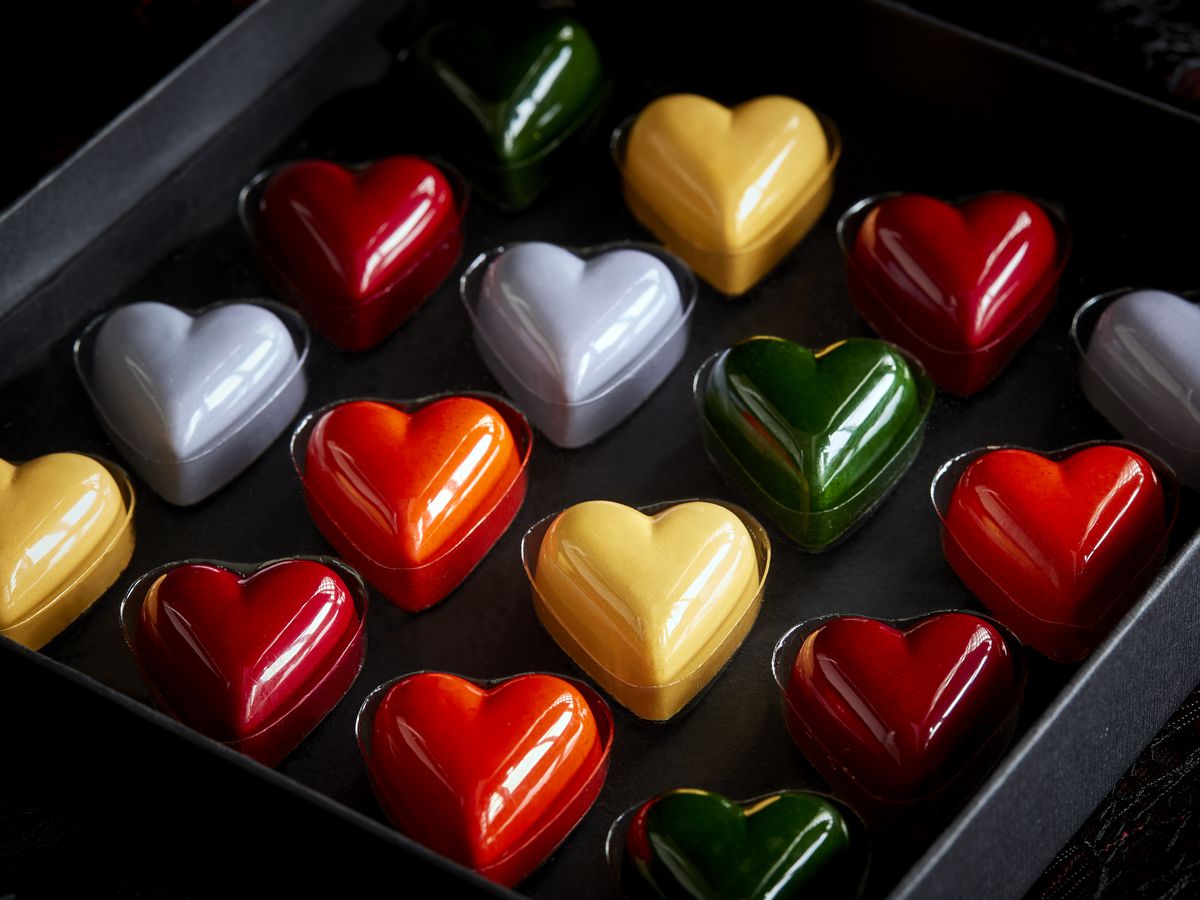 box of heart-shaped chocolates in different colors 