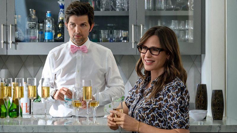 Adam Scott and Jennifer Garner in Party Down. He is tending bar; she is standing nearby with a drink.