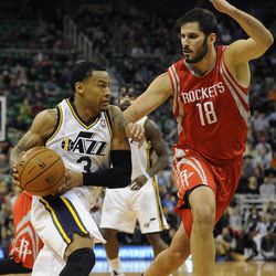 Utah Jazz point guard Trey Burke (3) drives to the basket as Houston Rockets small forward Omri Casspi (18) defends during a game at EnergySolutions Arena on Monday, Dec. 2, 2013.