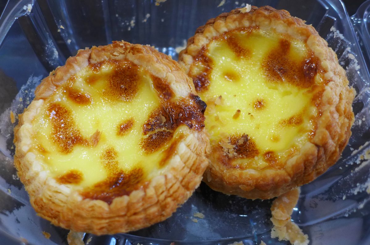 Two round pies filled with very yellow custard.