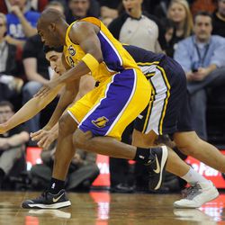 Utah Jazz center Enes Kanter (0) and Los Angeles Lakers shooting guard Jodie Meeks (20) both for a loose ball during a game at EnergySolutions Arena on Friday, Dec. 27, 2013.