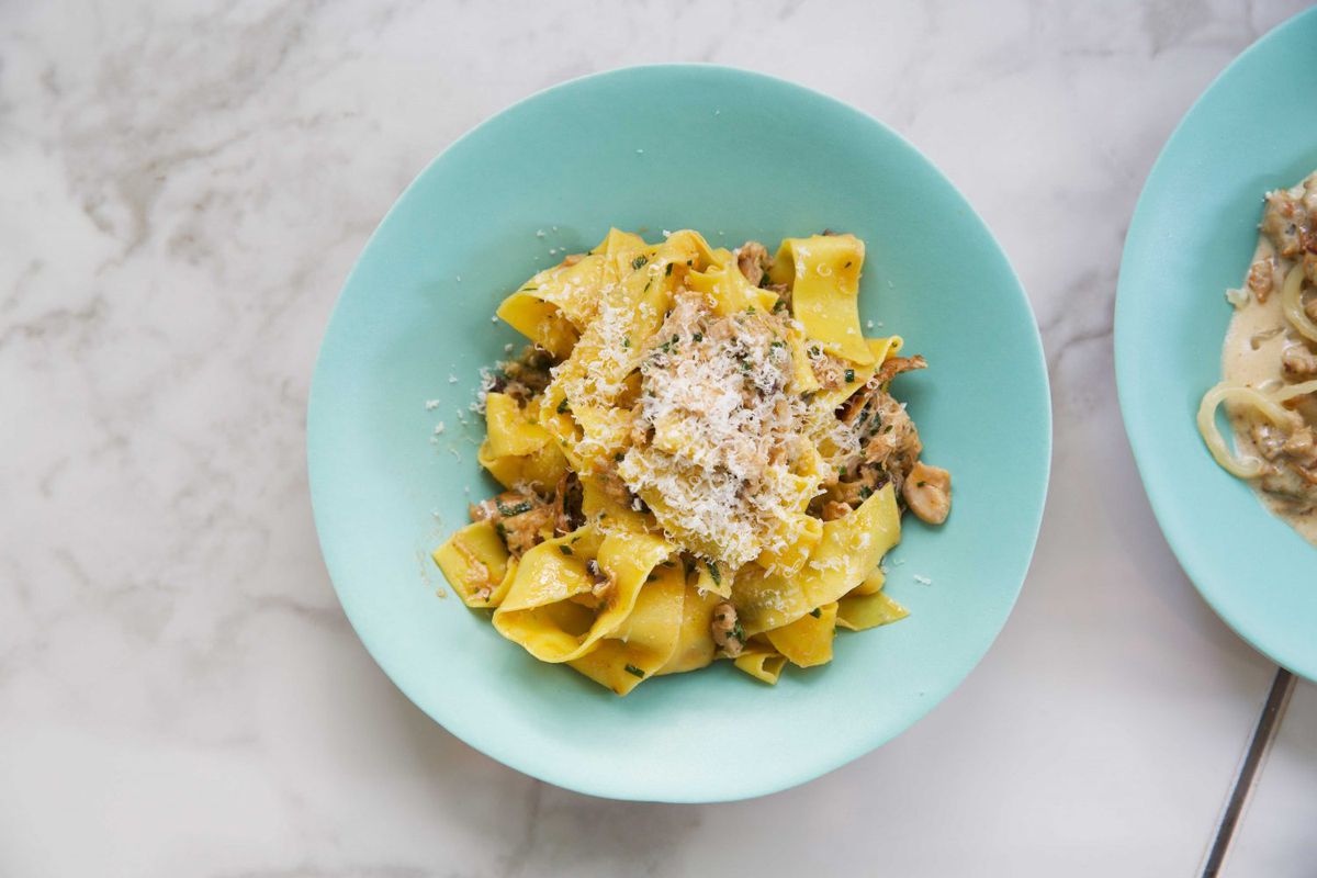 A turquoise bowl of pasta at Lina Stores in Soho