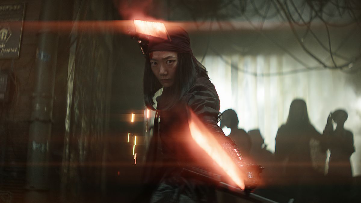 Doona Bae in Netflix’s Rebel Moon Part One: A Child of Fire, dual-wielding two suspiciously lightsaber-like glowing red plasma swords and staring into the camera