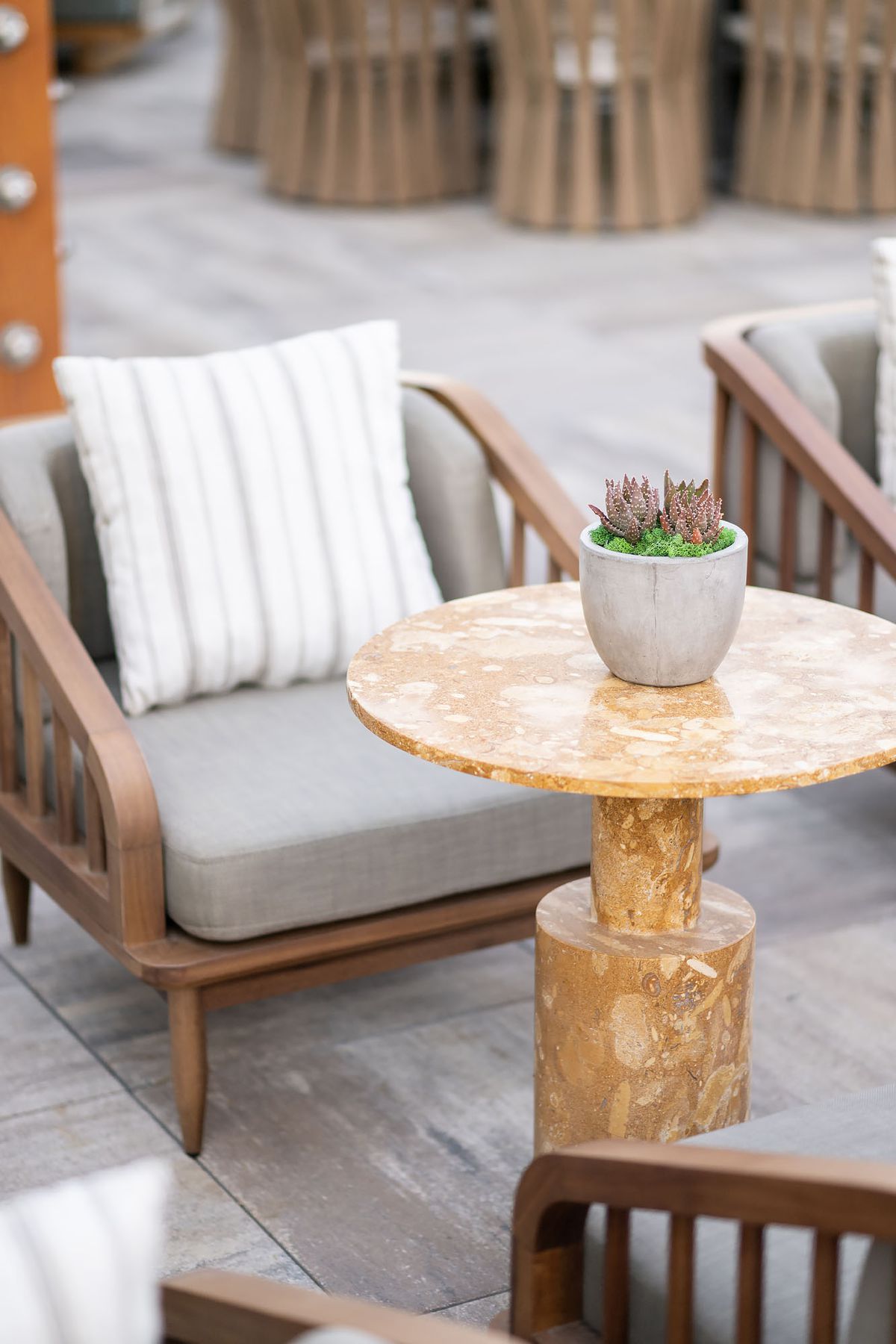 An off-tan table with marble looks at a new rooftop restaurant at sunset.