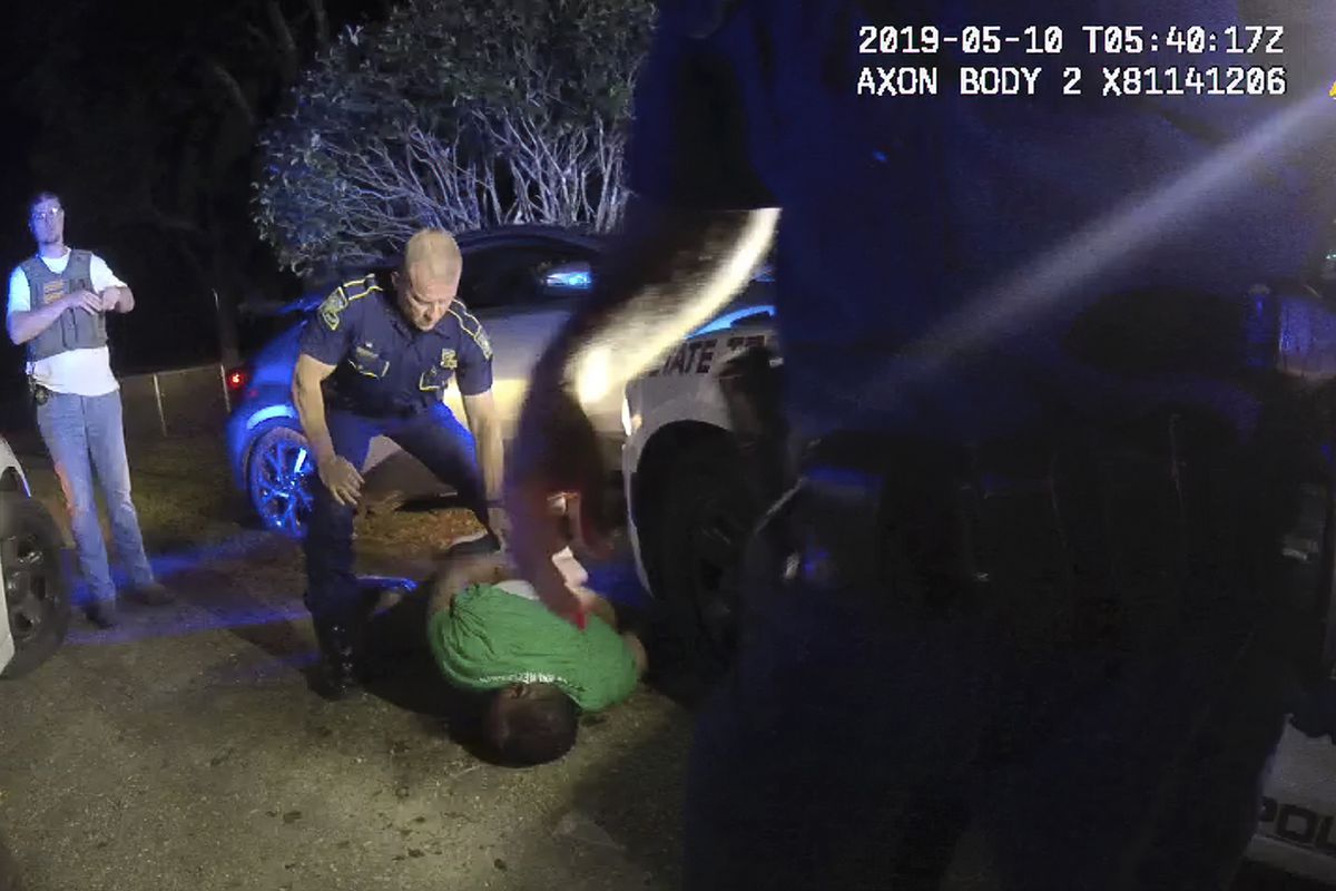 This image from video from Louisiana state trooper Lt. John Clary’s body-worn camera shows trooper Kory York standing over Ronald Greene on his stomach on May 10, 2019, outside of Monroe, La. 