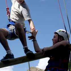 Dan Monaghan, of Omagh, Northern Ireland, helps PJ Mannebach of Salt Lake City during an Ulster Project activity at a ropes course outside the University of Utah Neuropsychiatric Institute in Salt Lake City on Wednesday, June 29, 2016. The Ulster Project’s mission is to help young, Christian-based potential leaders from Northern Ireland and the United States become peacemakers by providing a safe environment to learn and practice the skills needed to unite people when differences divide them. The Ulster Project of Utah has been bringing a dozen teens from Northern Ireland for a month each summer. Half the group comes from Catholic families and half from Protestant families.