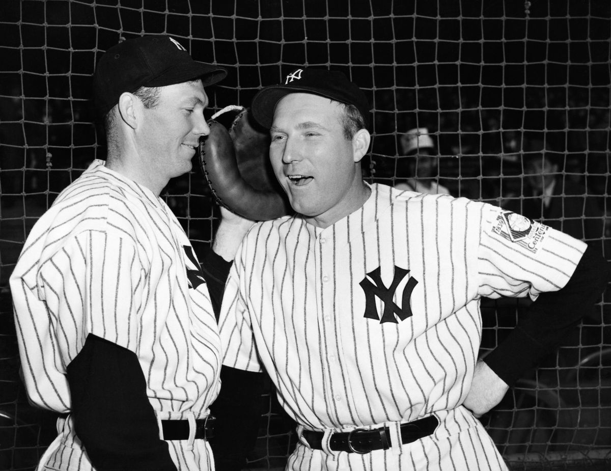 Red Ruffing and Bill Dickey Talking Near Baseball Net