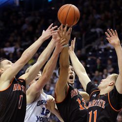 Idaho State Bengals guard Hayes Garrity (0), Brigham Young Cougars forward Eric Mika (12), Bengals center Novak Topalovic (13) and Bengals guard Erik Nakken (11) reach for a rebound during NCAA basketball in Provo on Tuesday, Dec. 20, 2016.