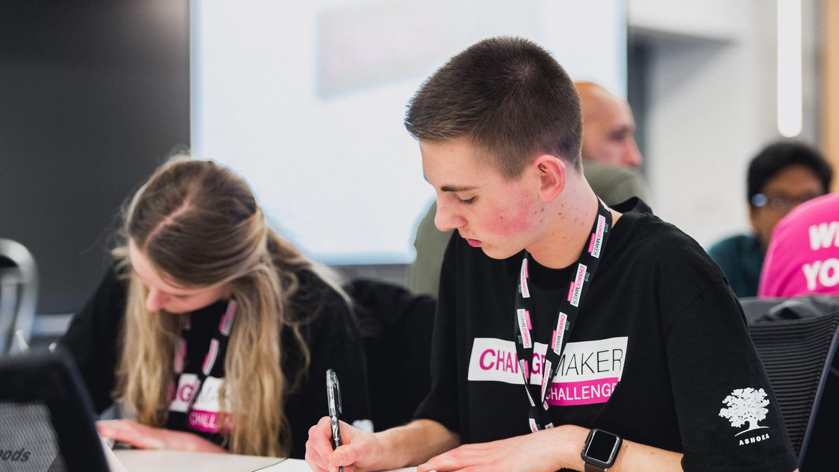 2 students seated at a desk participate in T-Mobile’s Changemaker Challenge