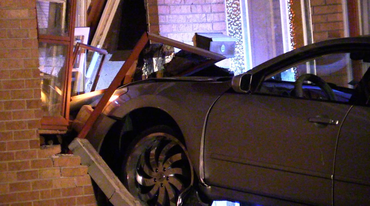 Police investigate a car that crashed into a house around 1 a.m. Monday, May 28, 2018 in the 300 block of East 170th St. in South Holland. | Justin Jackson/ Sun-Times
