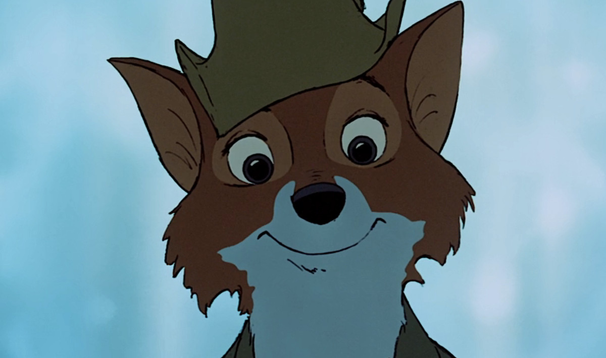 Disney’s Robin Hood, an anthropomorphic fox in green, smiles directly into the camera during the song “Love” in 1973’s Robin Hood