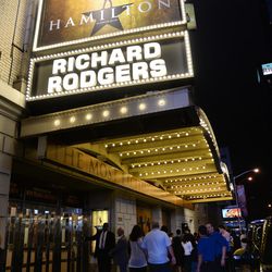 People gather outside the "Hamilton" marquee at the Richard Rogers Theatre on Saturday, July 9, 2016, in New York. The production is still on Broadway, but much of the original cast members have left the show.