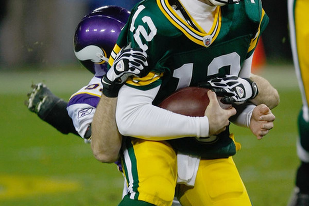 GREEN BAY, WI - NOVEMBER 14: Aaron Rogers #12 of the Green Bay Packers is sacked by Jared Allen #69 of the Minnesota Vikings at Lambeau Field on November 14, 2011 in Green Bay, Wisconsin. (Photo by Scott Boehm/Getty Images)