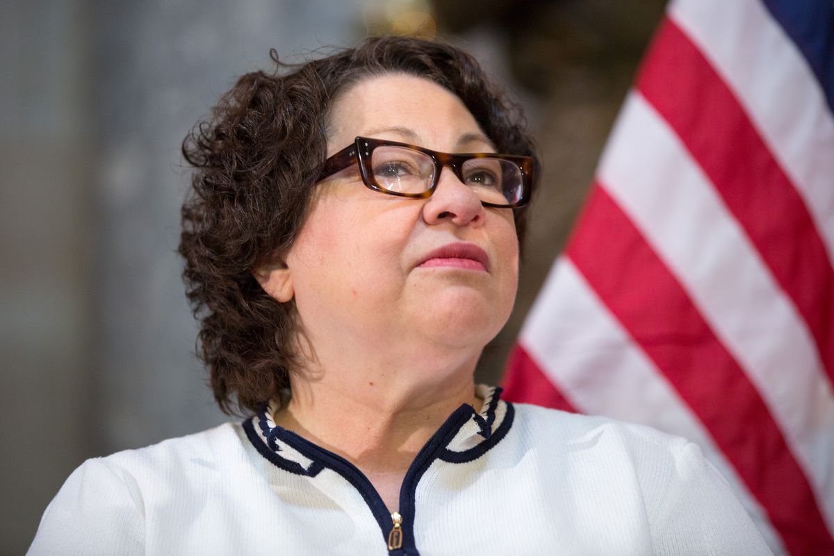 Sonia Sotomayor stands in front of the American flag.