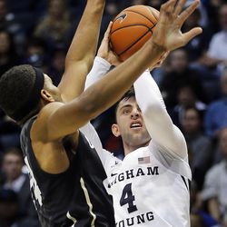 Brigham Young Cougars guard Nick Emery (4) takes a shot with Colorado Buffaloes guard George King (24) defending during an NCAA basketball game against Colorado in Provo on Saturday, Dec. 10, 2016.