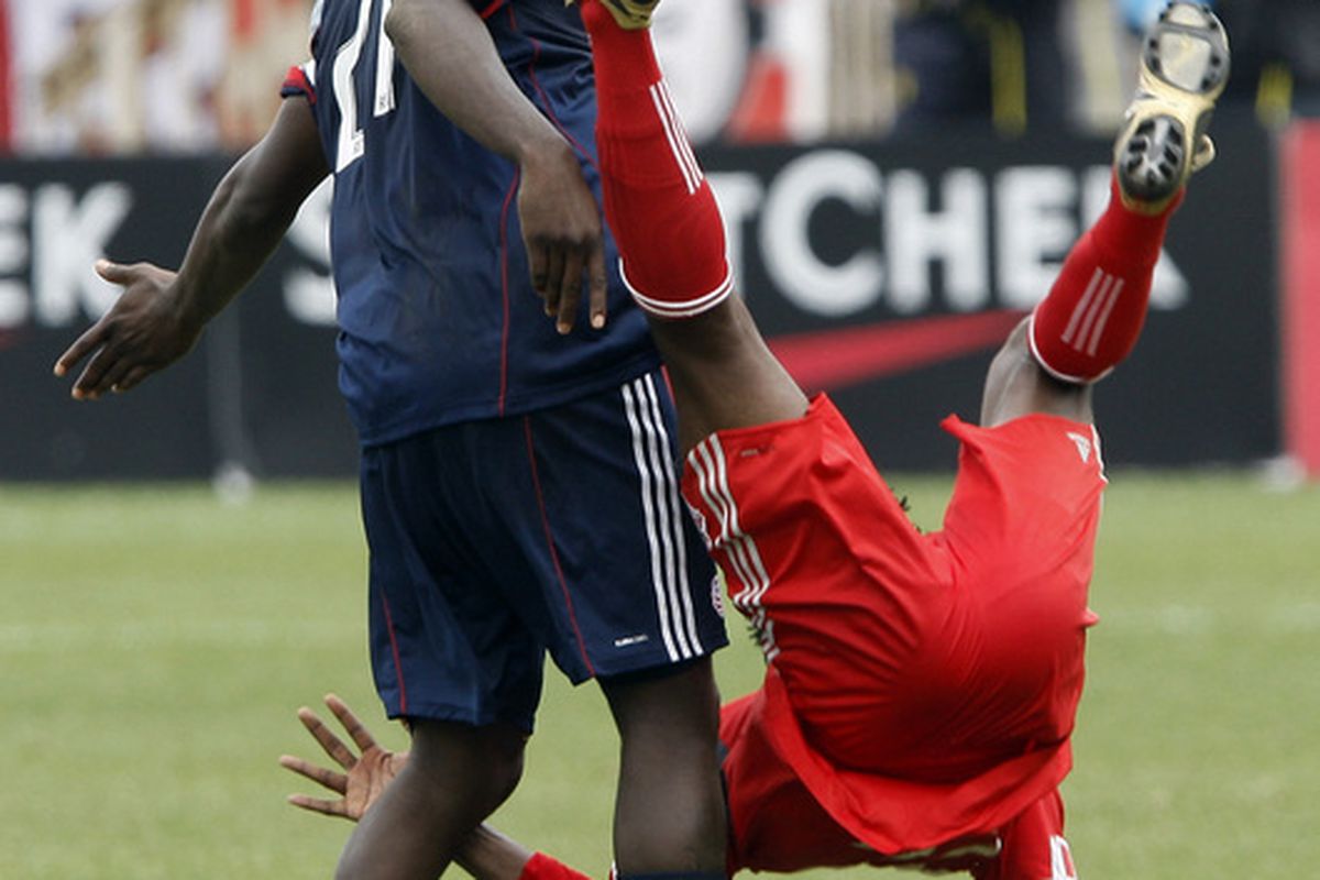 TORONTO - MAY 22: Amadou Sanyang #22 of Toronto FC gets hit by Shalrie Joseph #21 of the New England Revolution during a MLS game at BMO Field May 22, 2010 in Toronto, Ontario, Canada. (Photo by Abelimages/Getty Images)