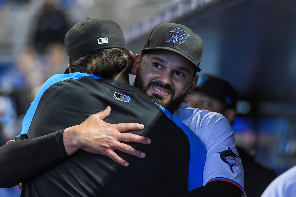 Pablo Lopez #49 of the Miami Marlins hugs Edward Cabrera #79 after being removed from the game in the second inning against the Philadelphia Phillies at loanDepot park on October 03, 2021 in Miami, Florida.