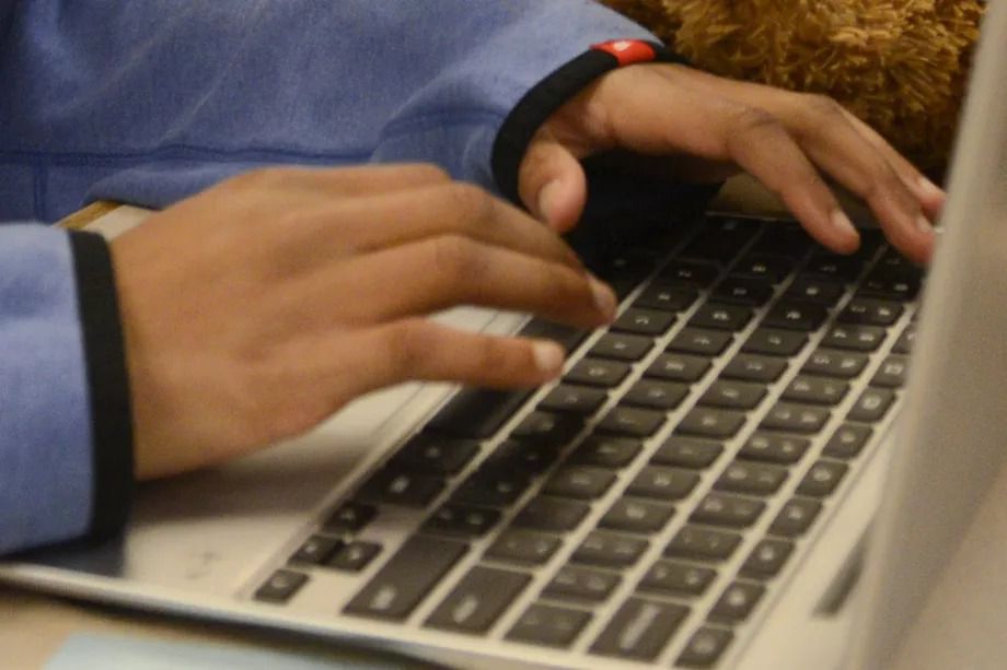 A Chicago Public Schools student types on a computer keyboard.