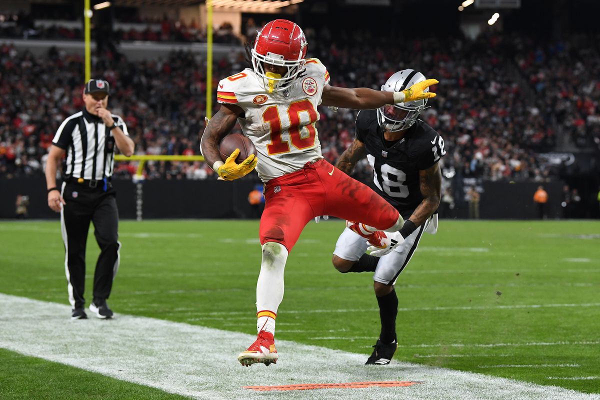 LAS VEGAS, NEVADA - NOVEMBER 26: Isiah Pacheco #10 of the Kansas City Chiefs is forced out of bounds by Jack Jones #18 of the Las Vegas Raiders during the fourth quarter at Allegiant Stadium on November 26, 2023 in Las Vegas, Nevada.