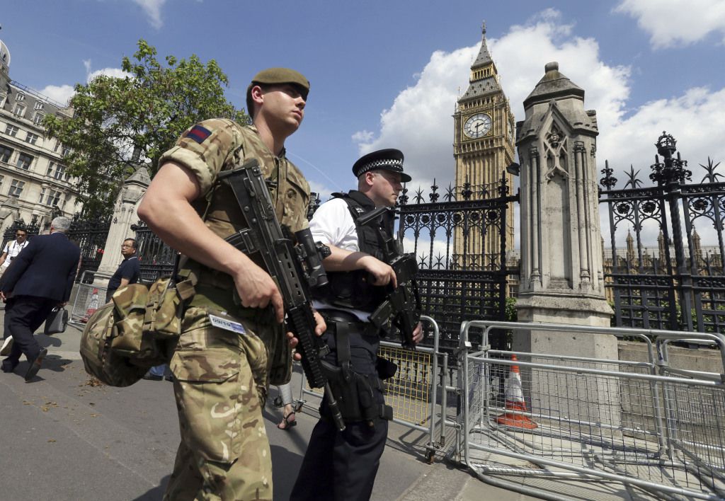 Police and soldiers on patrol in Westminster, London on Wednesday. The official threat level in Great Britain was raised to its highest point following the Manchester suicide bombing. | Tim Ireland/Associated Press