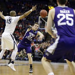 Weber State's McKay Cannon (24) passes to teammate Dusty Baker (25) while Xavier's Myles Davis defends during the first half in a first-round men's college basketball game in the NCAA tournament, Friday, March 18, 2016, in St. Louis. (AP Photo/Jeff Roberson)