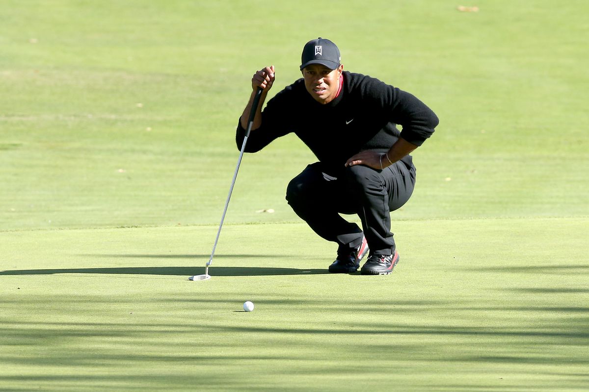 Tiger Woods lines up a putt on the fourth hole during the final round of the Northwestern Mutual World Challenge at Sherwood Country Club on December 8, 2013 in Thousand Oaks,
