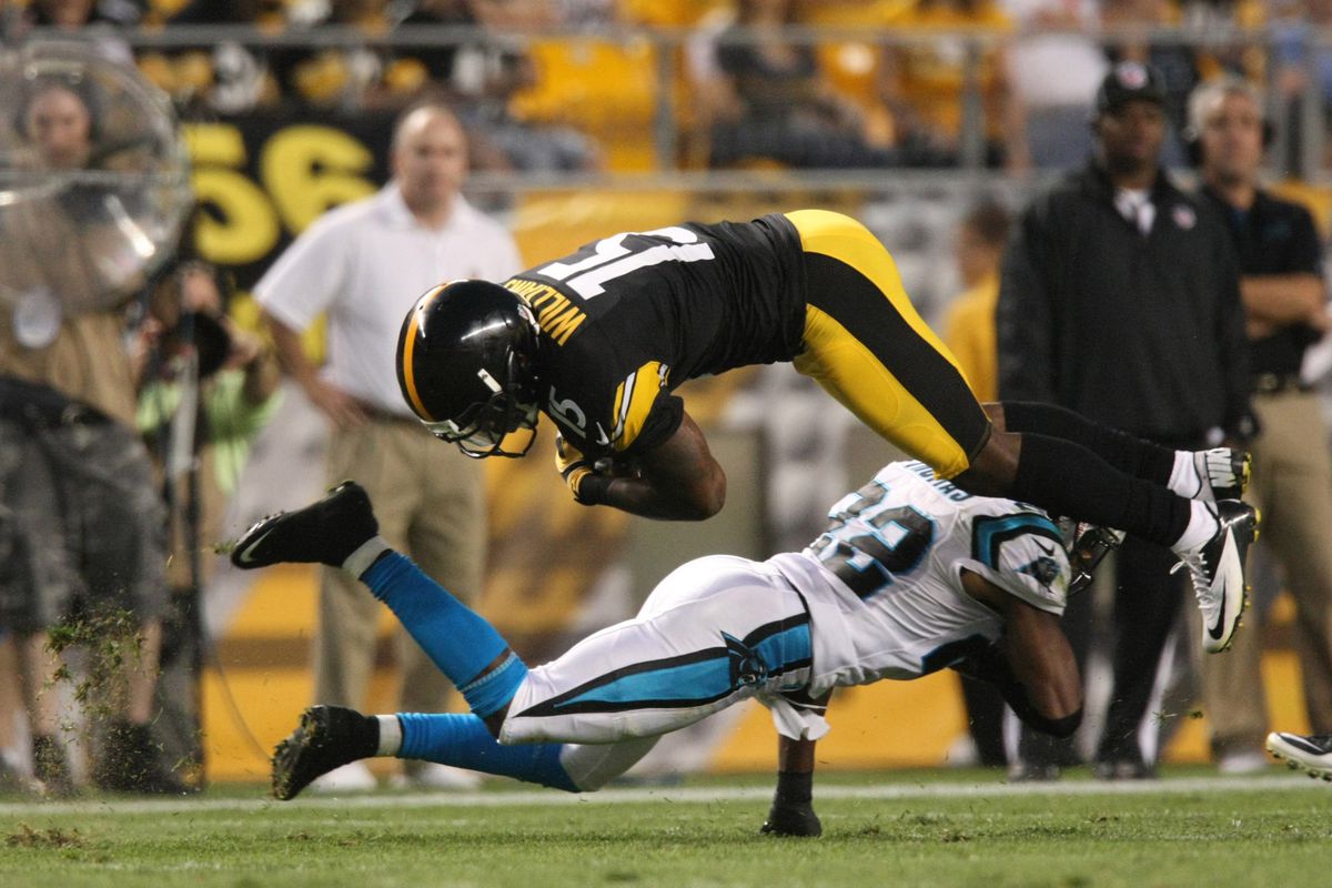 Aug 30, 2012; Pittsburgh , PA, USA; Pittsburgh Steelers wide receiver Derrick Williams (15) is tackled by Carolina Panthers cornerback Josh Thomas (22) during the first half of the game at Heinz Field. Mandatory Credit: Jason Bridge-US PRESSWIRE